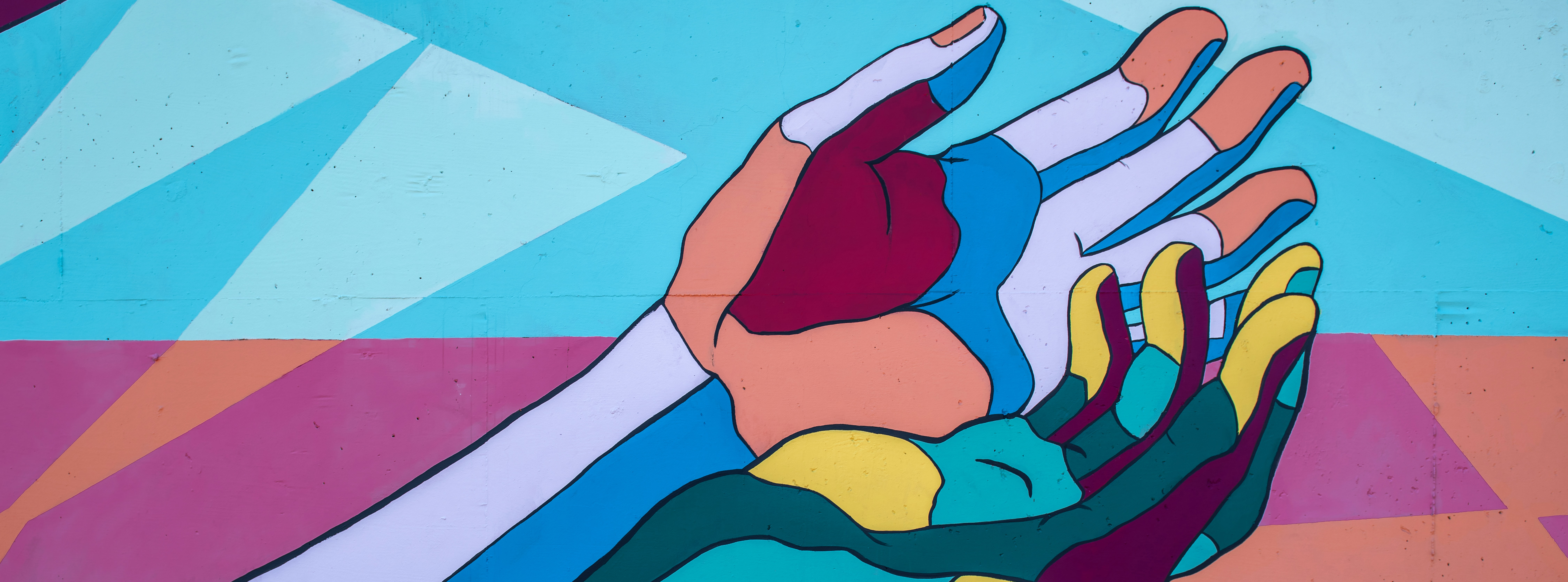 Colorful mural of two hands 